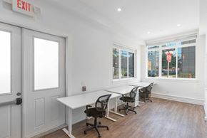 Philadelphia apartment for rent - a conference room with white walls and a row of tables and chairs