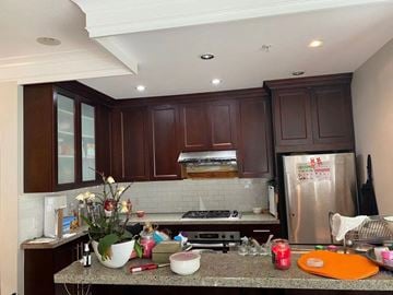Vancouver apartment for rent - A kitchen with brown cabinets and a granite countertop.