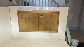Woonsocket apartment for rent - A set of four brown drawers are lined up on a white wall.