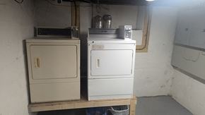 Woonsocket apartment for rent - Two white appliances on a shelf in a room.