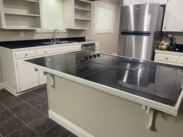 Lafayette house for rent - A kitchen with a stove top oven and a refrigerator.