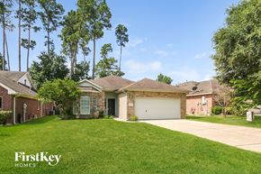 Conroe house for rent - a home with a lawn and a garage
