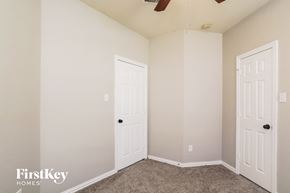 Conroe house for rent - a bedroom with two closets and two doors
