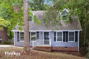 Trinity house for rent - A house with a porch and a tree in front of it.