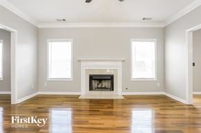 Hiram house for rent - an empty living room with a fireplace and wooden floors