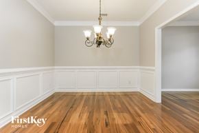 Hiram house for rent - the living room of a house with wood floors and a chandelier