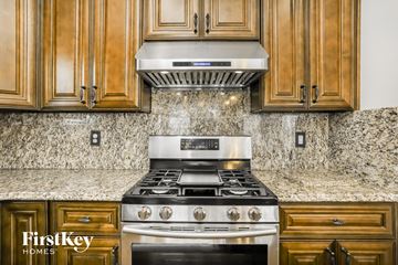 Hiram house for rent - a kitchen with wood cabinets and a stainless steel stove