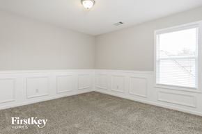 Hiram house for rent - a bedroom with white walls and carpet and a window