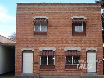 Gooding apartment for rent - a brick building with three windows and a white door