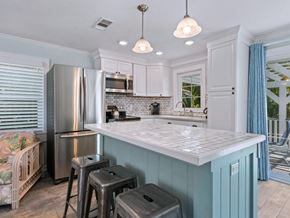 Holmes Beach house for rent - a blue and white kitchen with a counter top