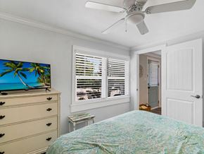 Holmes Beach house for rent - a bedroom with a bed and a ceiling fan