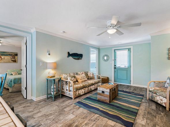 Holmes Beach house for rent - a living room with furniture and a ceiling fan