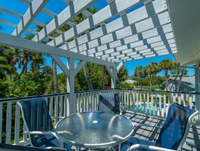 Holmes Beach house for rent - a patio with a table and chairs and a pool