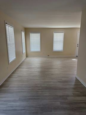 New Haven apartment for rent - A room with wooden floors and two windows.
