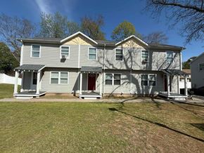 New Haven apartment for rent - A two-story house with a grey exterior and a red door.