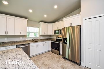 Lehigh Acres house for rent - the kitchen is updated with stainless steel appliances and granite counter tops