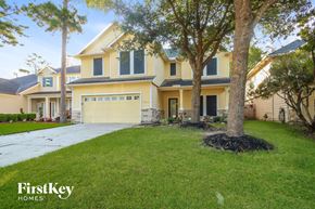 Humble house for rent - a large yellow house with a driveway and a tree