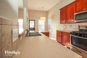 Humble house for rent - a kitchen with a large counter top and a sink