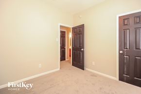 Humble house for rent - a bedroom with two doors and a carpeted floor