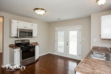 Westfield house for rent - A kitchen with a microwave and oven built into the cabinetry.