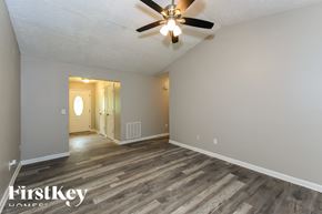 Kennesaw house for rent - A room with a ceiling fan and wooden flooring.