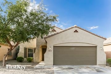 Laveen house for rent - a house with a garage door and a tree
