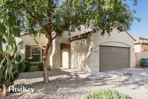Laveen house for rent - a white house with a garage door and a tree