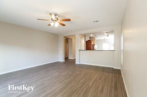 Laveen house for rent - an empty living room with wood flooring and a ceiling fan