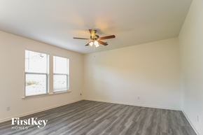 Winston Salem house for rent - A room with a ceiling fan and a window.