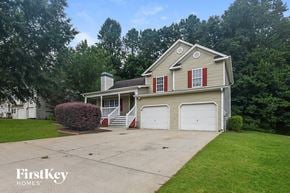 Acworth house for rent - A two-story house with a garage and a chimney.