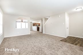 Camby house for rent - A spacious room with a carpeted floor and a wooden floor in the corner.