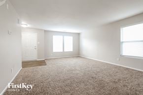 Camby house for rent - A spacious room with a carpeted floor and a door leading to another room.