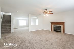 Camby house for rent - A spacious living room with a fireplace and a staircase.