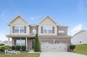 Mooresville house for rent - a home with a white garage door and a brick house