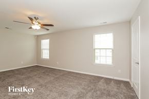 Mooresville house for rent - a bedroom with carpet and a ceiling fan