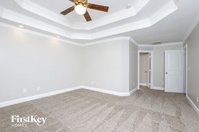Clemmons house for rent - A spacious room with a ceiling fan and carpeted floor.