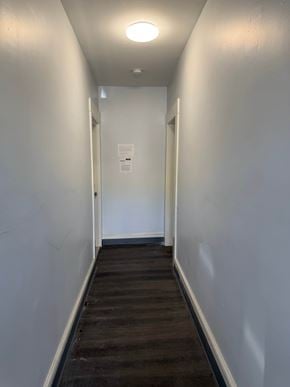 New Haven apartment for rent - A long hallway with a white wall and a door at the end.