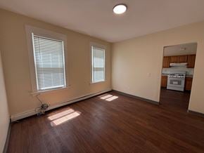 New Haven apartment for rent - A room with wooden floors and two windows.