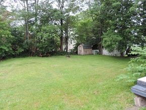 New Glasgow apartment for rent - a large yard with trees and a house in the background