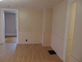 New Glasgow apartment for rent - A room with wooden floors and white walls.