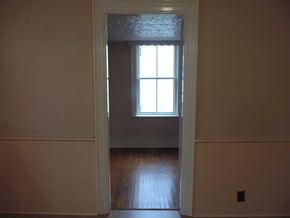 New Glasgow apartment for rent - A room with a window and wooden floors.
