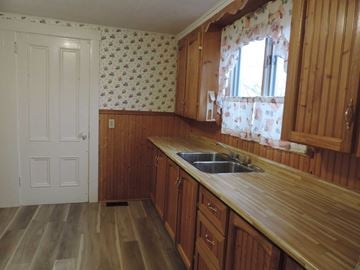 New Glasgow apartment for rent - A kitchen with wooden cabinets and a sink.
