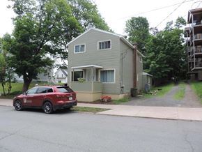 New Glasgow apartment for rent - a house with a red car parked in front of it