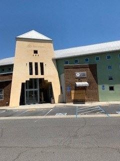 Napa apartment for rent - A building with a tall entrance and a small tower on top.