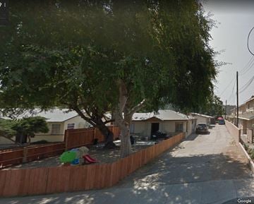 Glendora house for rent - a street with houses and trees and a fence