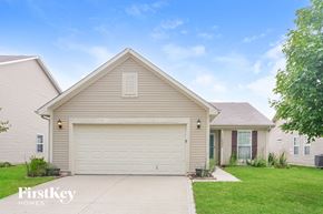 Noblesville house for rent - a beige house with a white garage door