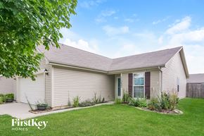 Noblesville house for rent - a white house with a lawn in front of it