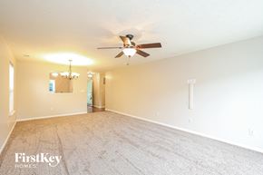 Noblesville house for rent - a living room with a ceiling fan and a carpeted floor