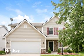 Noblesville house for rent - a tan house with a white garage door