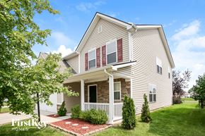 Noblesville house for rent - a white house with red shutters and a lawn and trees